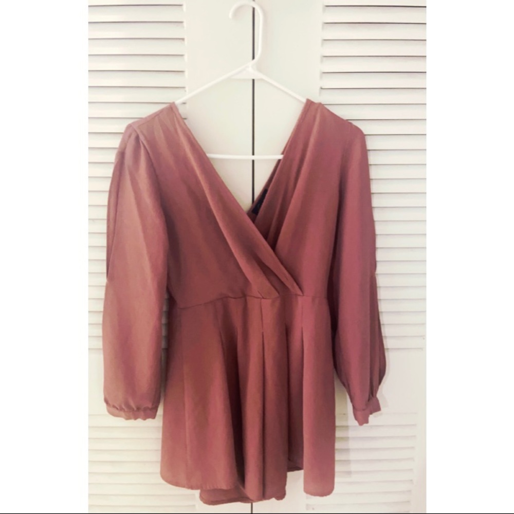 Deep coral open shoulder and v-cut romper.
